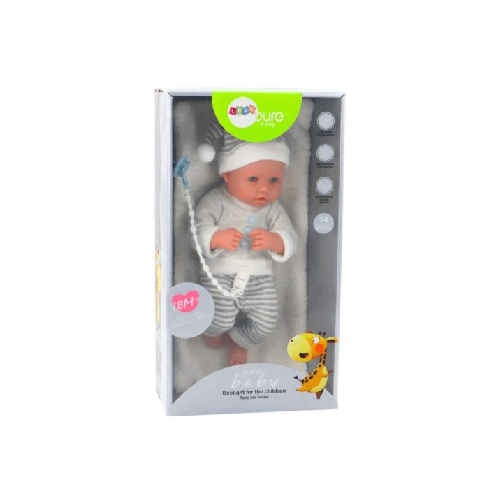 Baby doll in white and gray striped clothes, hat, pacifier, quilt