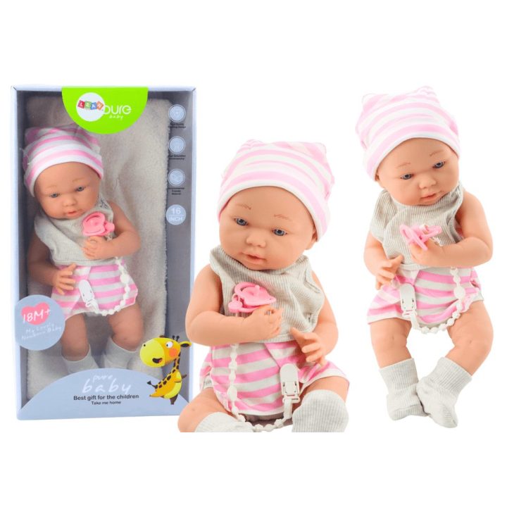 Baby doll in white and pink clothes, hat, pacifier, bib, quilt